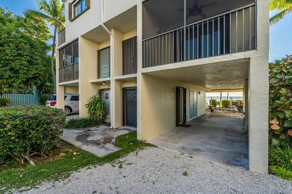 a kitchen with stainless steel appliances kitchen island granite countertop a refrigerator and cabinets