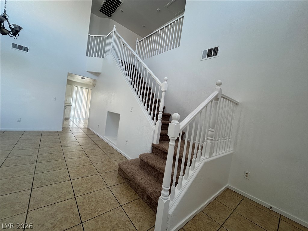 7373 Randel Jean Way Las Vegas, NV 89113 - Photo 9 of 14 Gleaming tile floors and a soaring staircase define this welcoming entry.