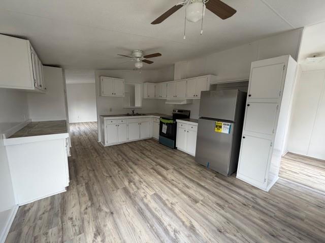 45 Banister Drive Northeast Rome, GA 30161 - Photo 9 of 19 a kitchen with stainless steel appliances granite countertop a refrigerator a sink dishwasher a stove and white countertops with wooden floor
