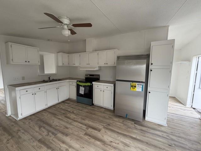 45 Banister Drive Northeast Rome, GA 30161 - Photo 10 of 19 a kitchen with granite countertop a refrigerator a sink a stove and white cabinets
