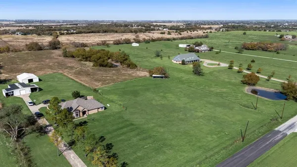 a view of a lake with huge green field and covered with green space