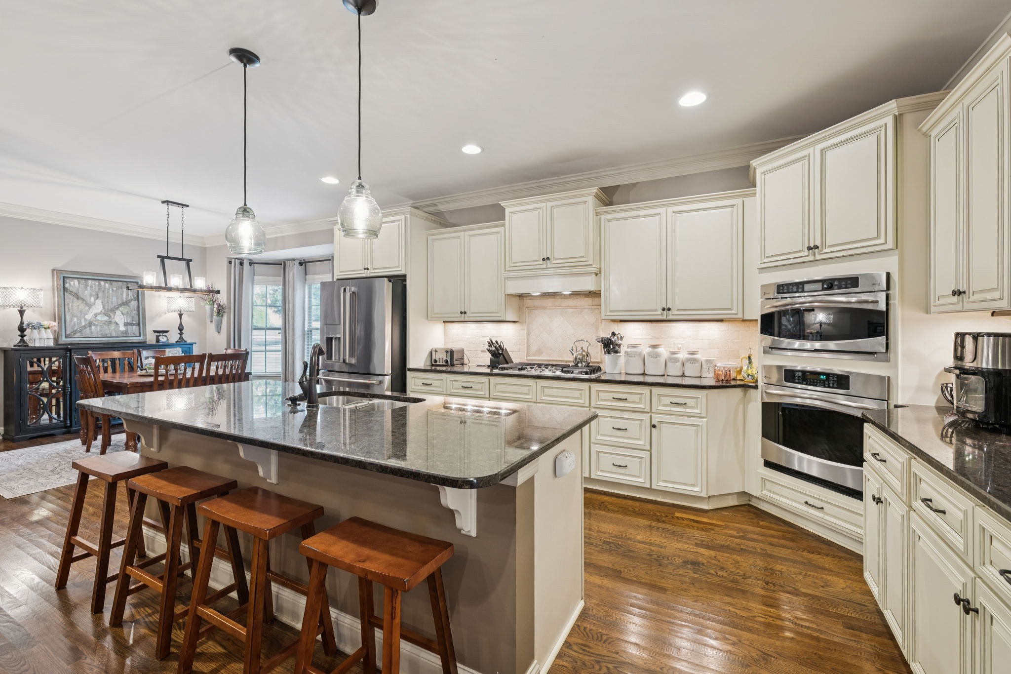 4003 Campania Strada Spring Hill, TN 37174 - Photo 16 of 50 a kitchen with kitchen island granite countertop lots of counter top space and stainless steel appliances
