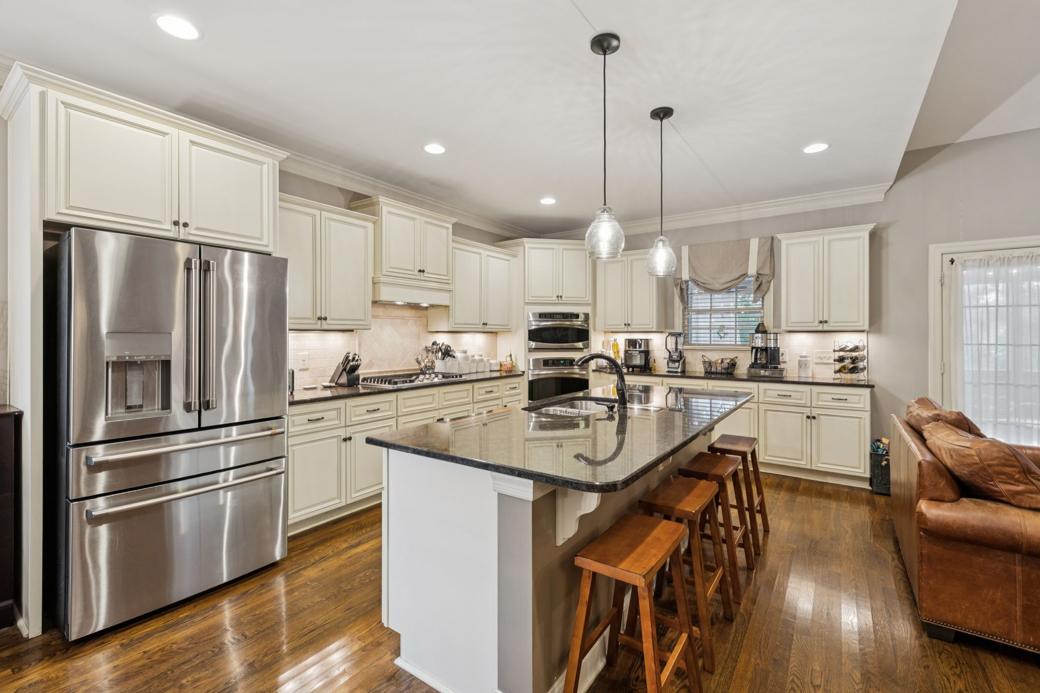 4003 Campania Strada Spring Hill, TN 37174 - Photo 17 of 50 a kitchen with stainless steel appliances granite countertop a refrigerator a sink dishwasher a stove and white cabinets with wooden floor
