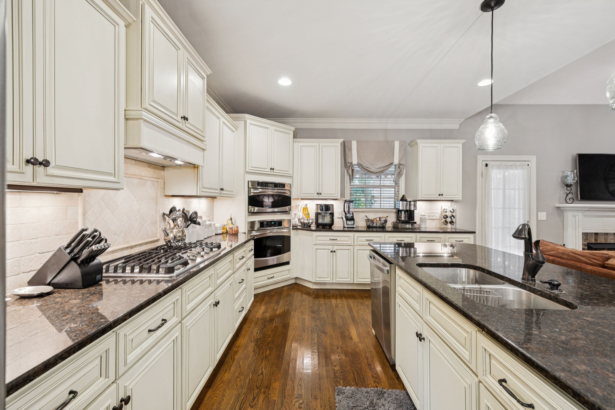 4003 Campania Strada Spring Hill, TN 37174 - Photo 19 of 50 a kitchen with kitchen island granite countertop a sink a counter space appliances and cabinets