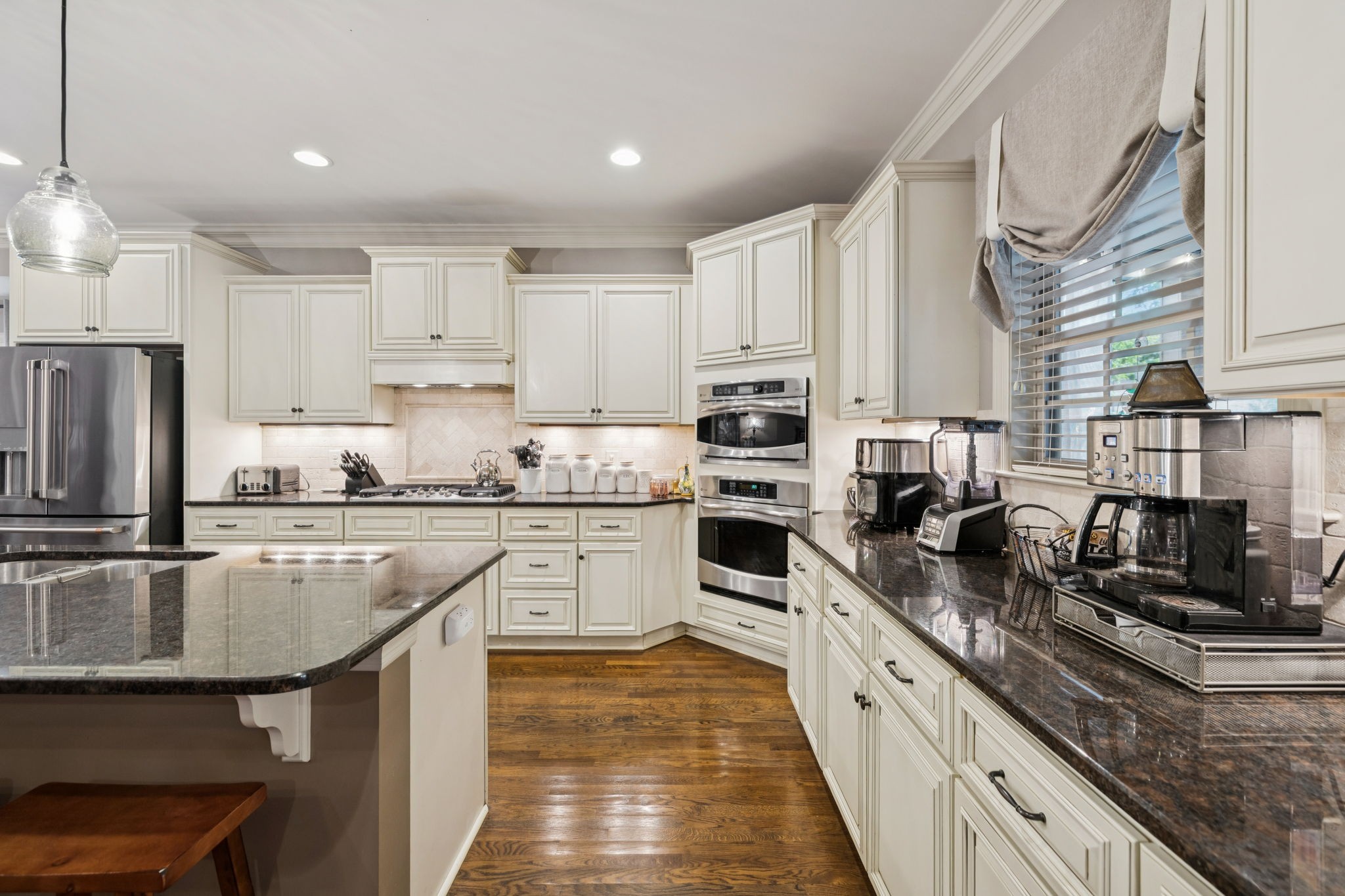 4003 Campania Strada Spring Hill, TN 37174 - Photo 22 of 50 a kitchen with kitchen island granite countertop a stove sink and refrigerator