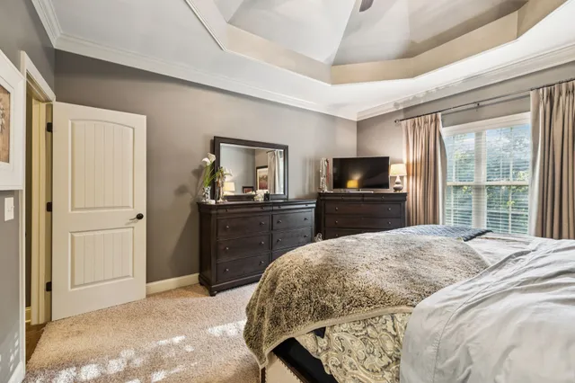 a bedroom with a bed and a dresser