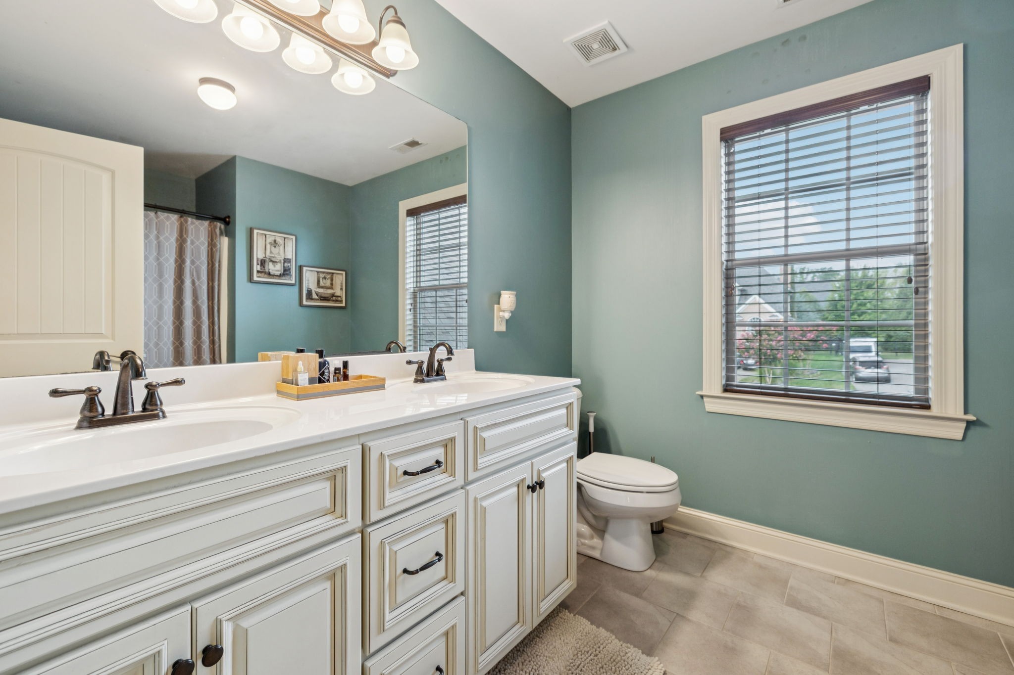 4003 Campania Strada Spring Hill, TN 37174 - Photo 37 of 50 a bathroom with a sink a toilet and a mirror