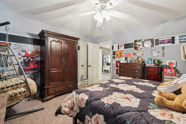 a bedroom with a bed and a chandelier
