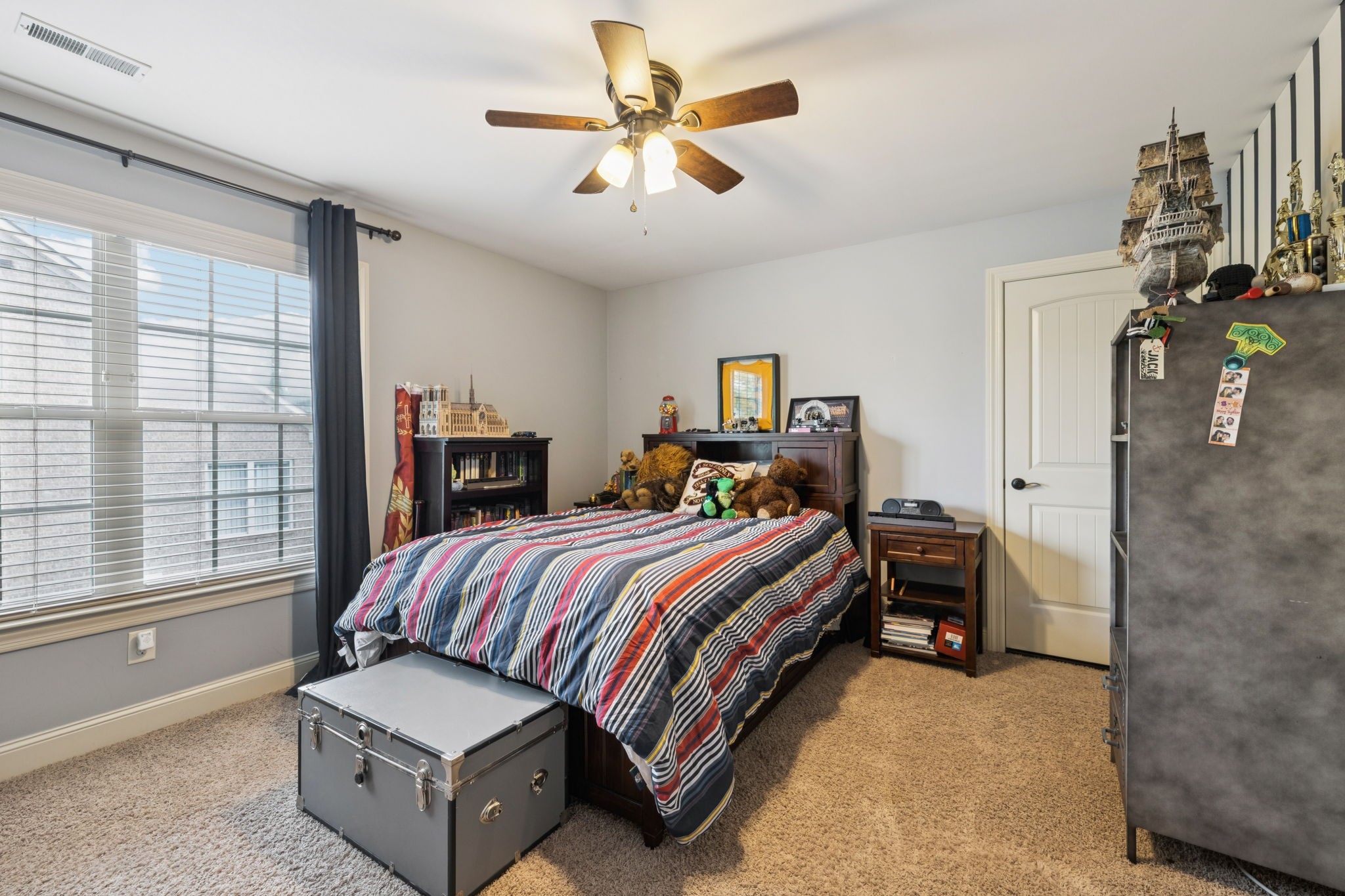 4003 Campania Strada Spring Hill, TN 37174 - Photo 40 of 50 a bedroom with a bed and a chandelier