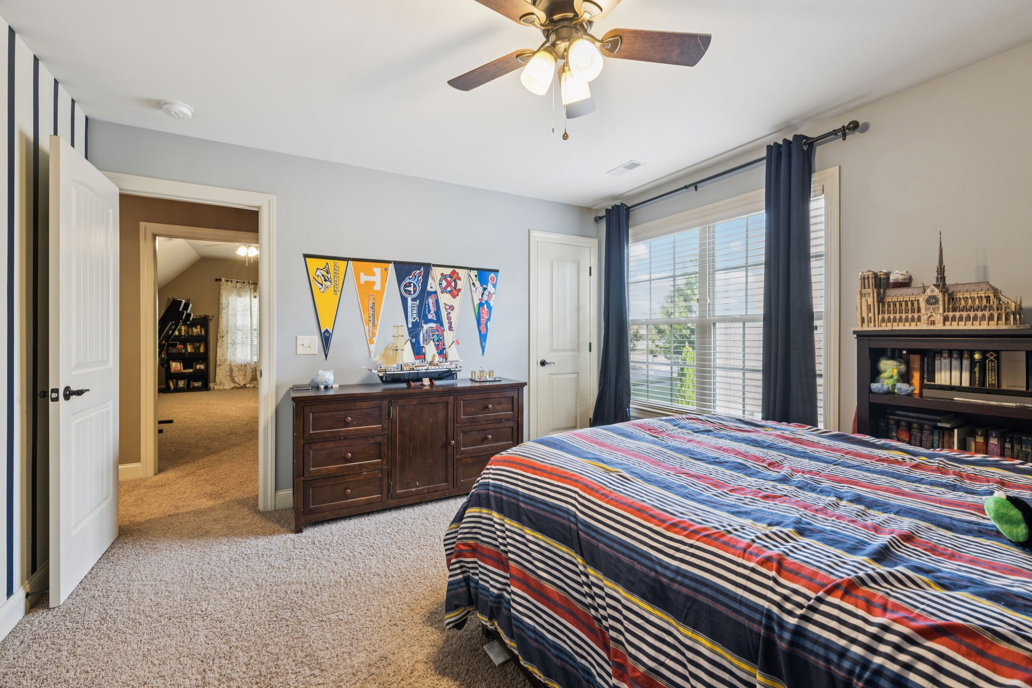 4003 Campania Strada Spring Hill, TN 37174 - Photo 41 of 50 a bedroom with a bed and a chandelier