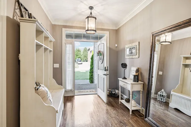 a view of entryway and hall with wooden floor