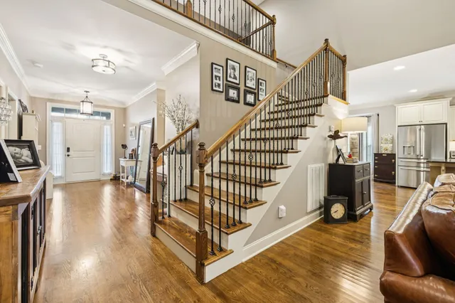 a living room with furniture wooden floor and a flat screen tv