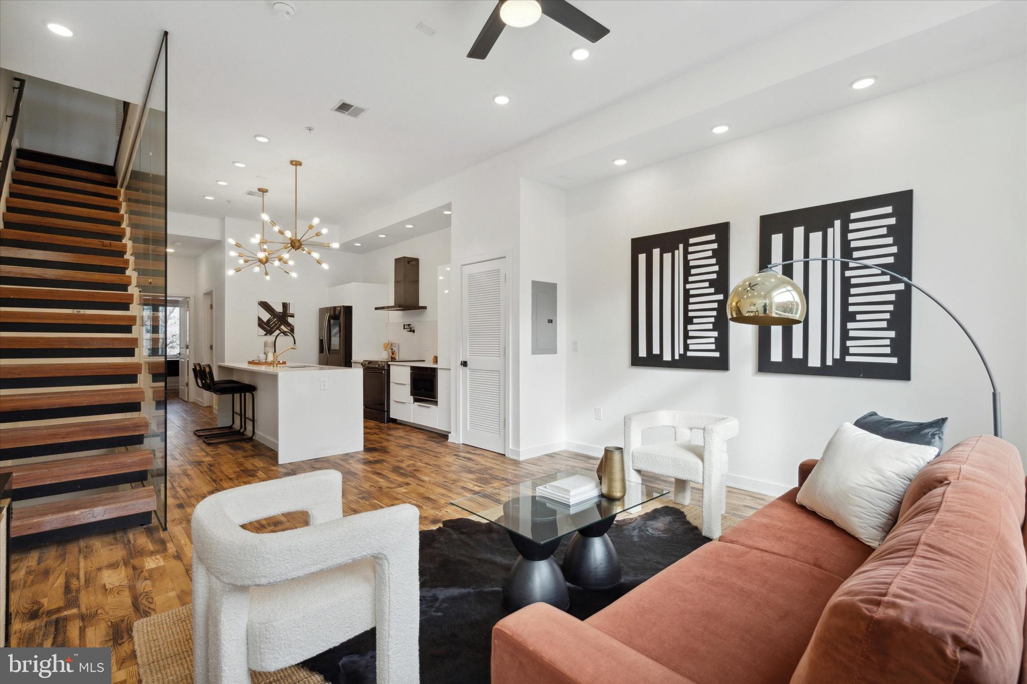 1825 Ginnodo Street, Unit R2 Philadelphia, PA 19130 - Photo 14 of 38 a living room with furniture a chandelier and a dining table