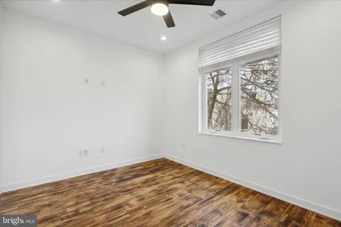 a bedroom with furniture and wooden floor