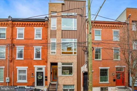 a kitchen with sink a stove and chairs