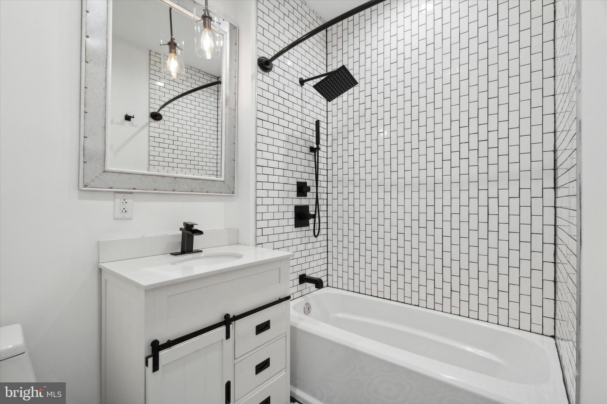 1825 Ginnodo Street, Unit R2 Philadelphia, PA 19130 - Photo 24 of 38 a bathroom with a bathtub and a sink