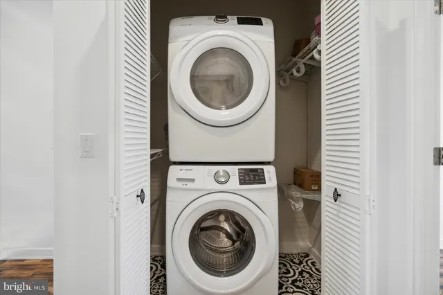 a living room with stainless steel appliances kitchen island granite countertop a sink and cabinets