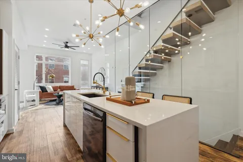 a kitchen with kitchen island a sink stove and refrigerator