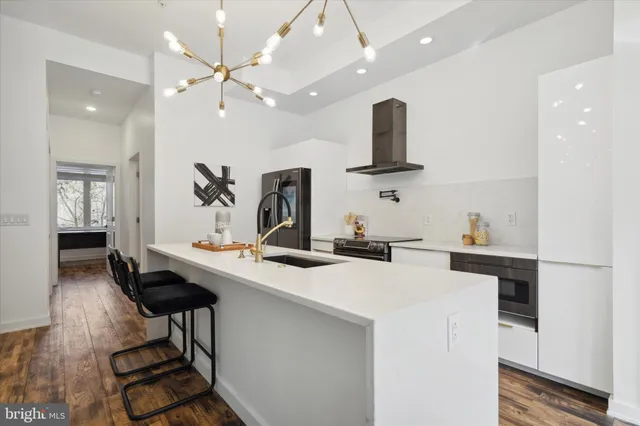 a view of a kitchen with cabinets and wooden floor