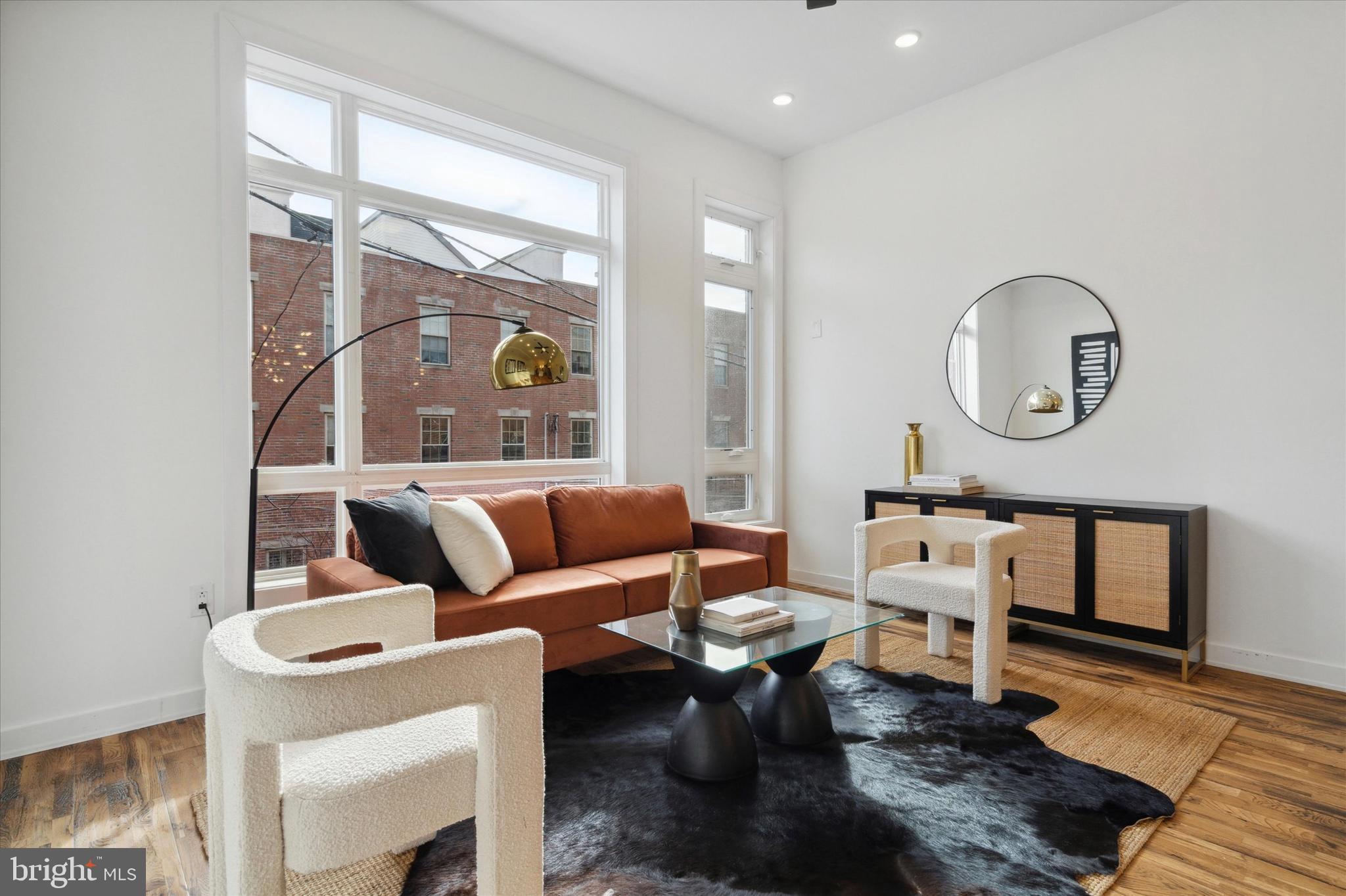 1825 Ginnodo Street, Unit R2 Philadelphia, PA 19130 - Photo 10 of 38 a living room with furniture a rug and a window
