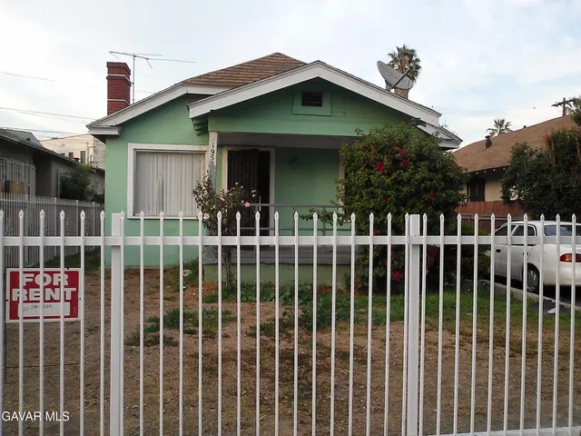 a view of a house with a small yard and plants