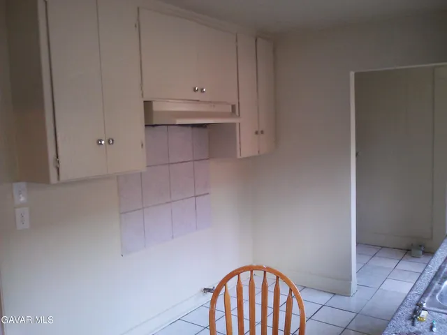 a view of room with cabinets and a floor to ceiling window