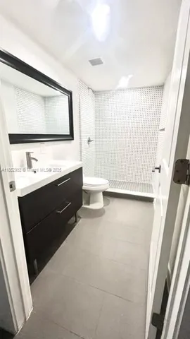 a room with a sink vanity and mirror