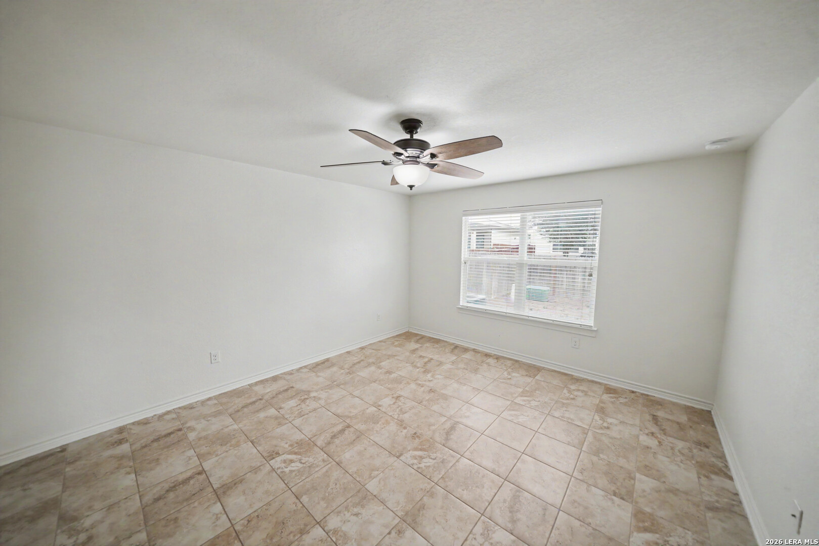 7506 Copper Cove Converse, TX 78109 - Photo 20 of 45 an empty room with windows and chandelier fan