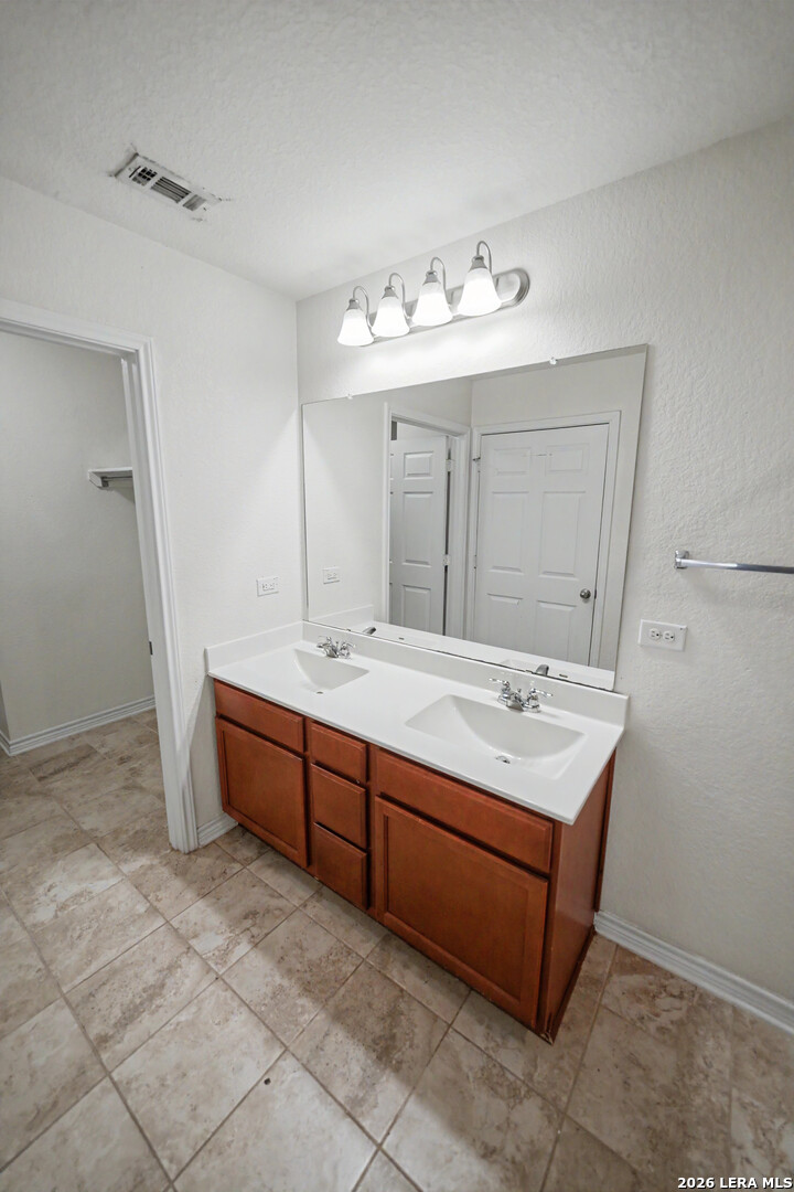 7506 Copper Cove Converse, TX 78109 - Photo 24 of 45 a bathroom with a double vanity sink and a mirror