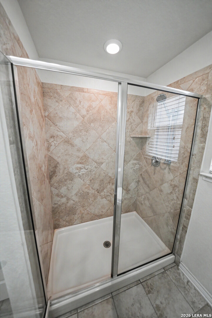7506 Copper Cove Converse, TX 78109 - Photo 30 of 45 a bathroom with a glass shower door