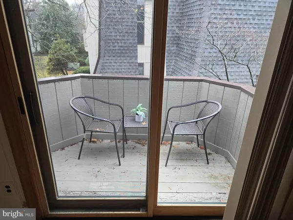 a view of a room with a table and chairs