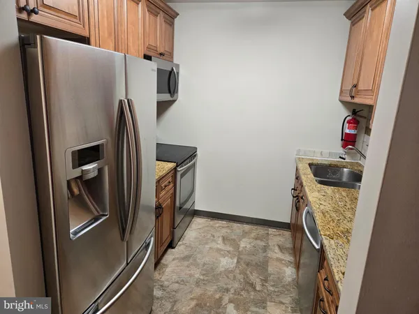 a kitchen with refrigerator and washing machine