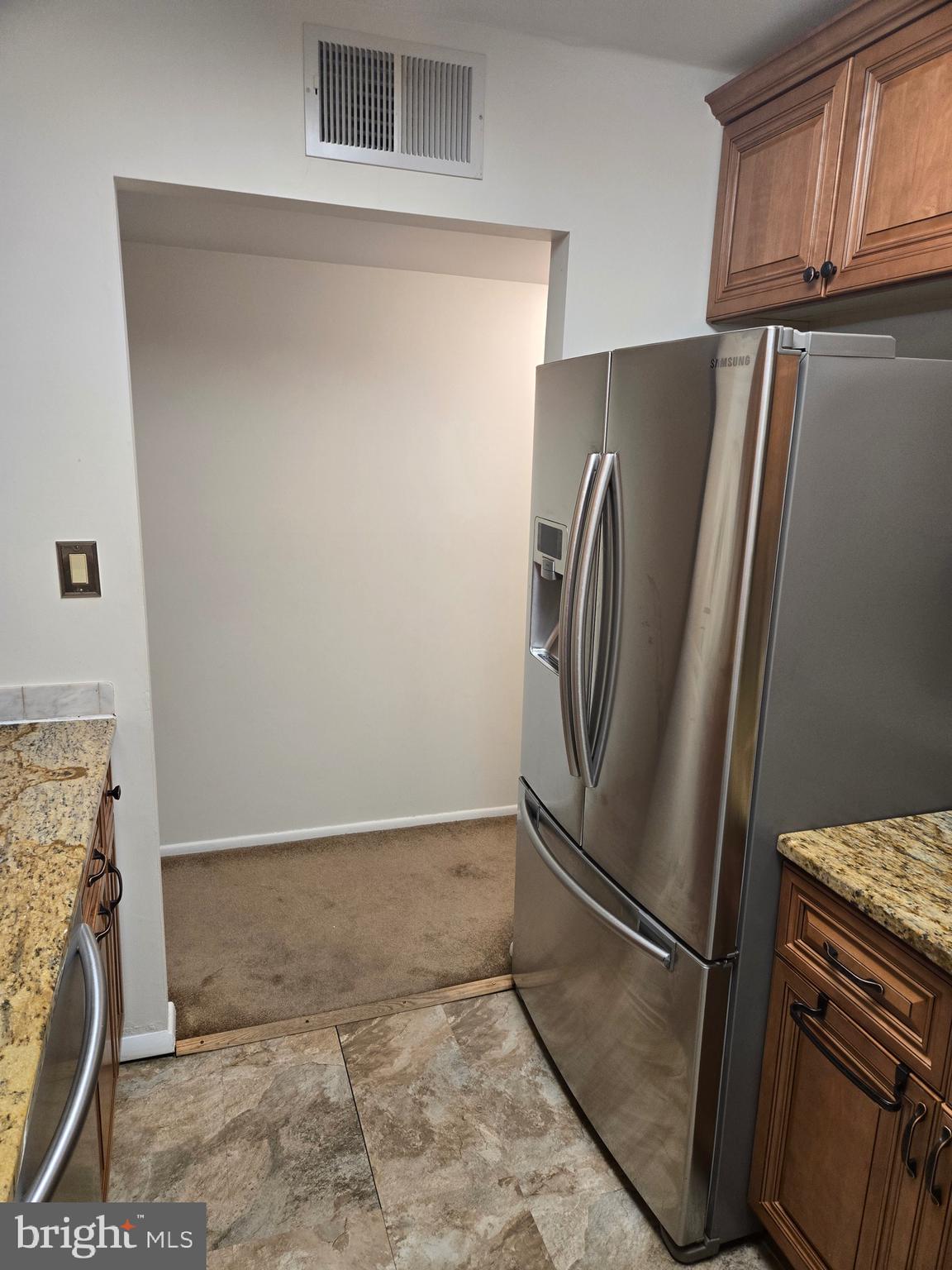 25 South Church Road, Unit 36 Maple Shade, NJ 08052 - Photo 3 of 8 a view of a refrigerator in kitchen and an empty room