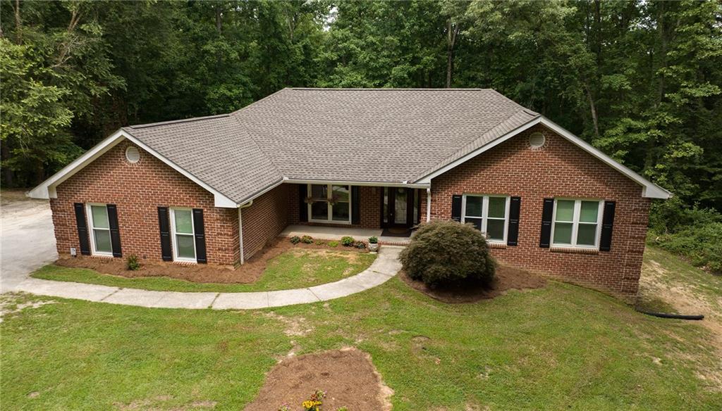 107 Lambert Road Whitesburg, GA 30185 - Photo 1 of 1 a front view of a house with a yard and garage