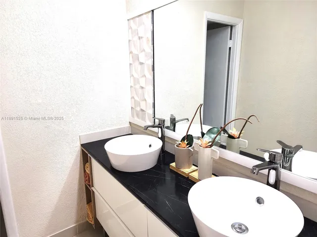 a view of a hallway with furniture and a floor to ceiling window