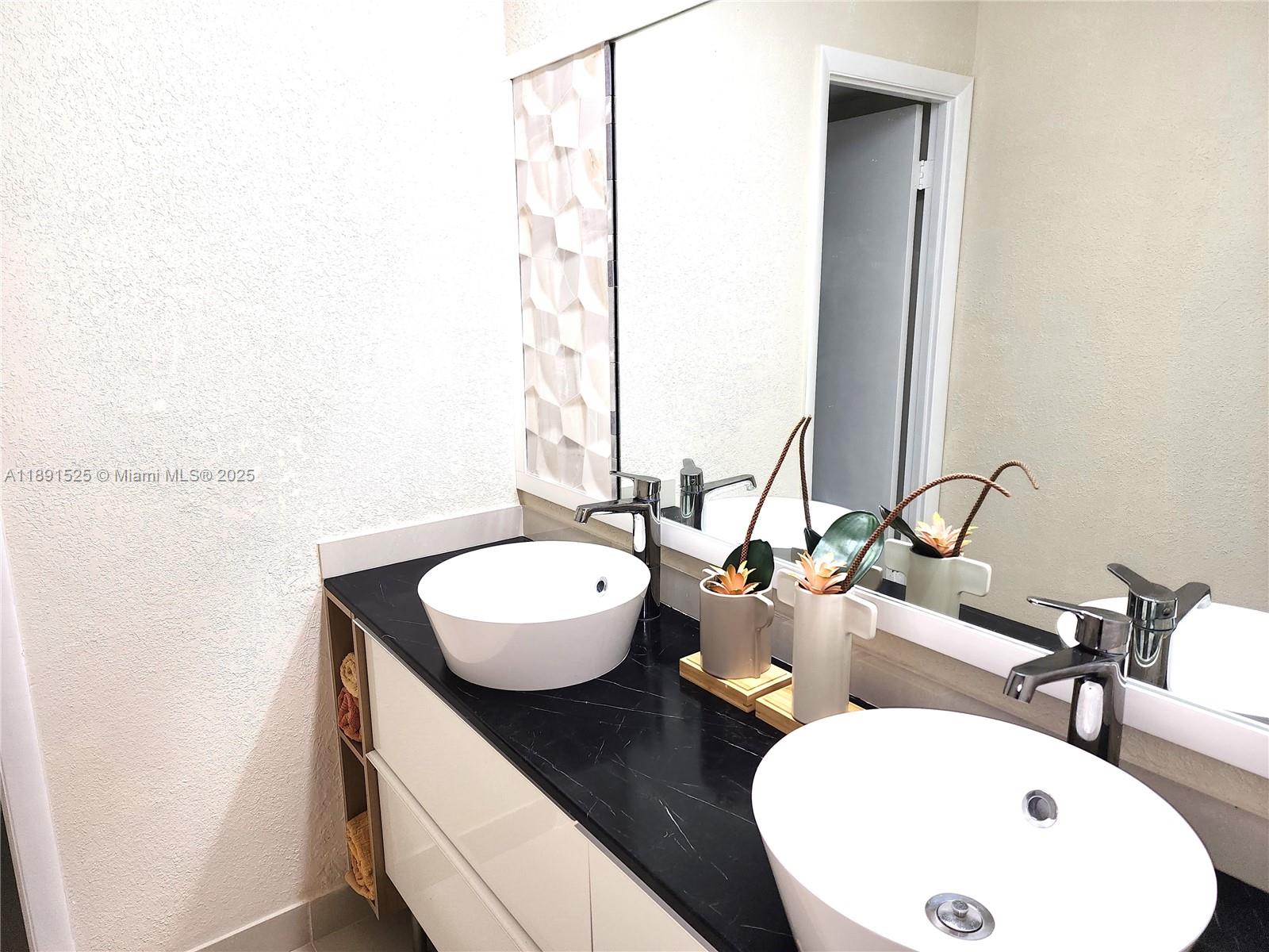 800 Southeast 20th Avenue, Unit 1109 Deerfield Beach, FL 33441 - Photo 16 of 19 a bathroom with a double vanity sink and a mirror