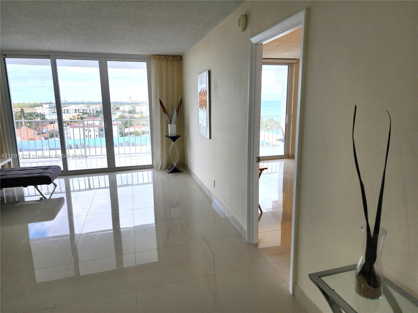 800 Southeast 20th Avenue, Unit 1109 Deerfield Beach, FL 33441 - Photo 17 of 19 a view of a hallway with furniture and a floor to ceiling window