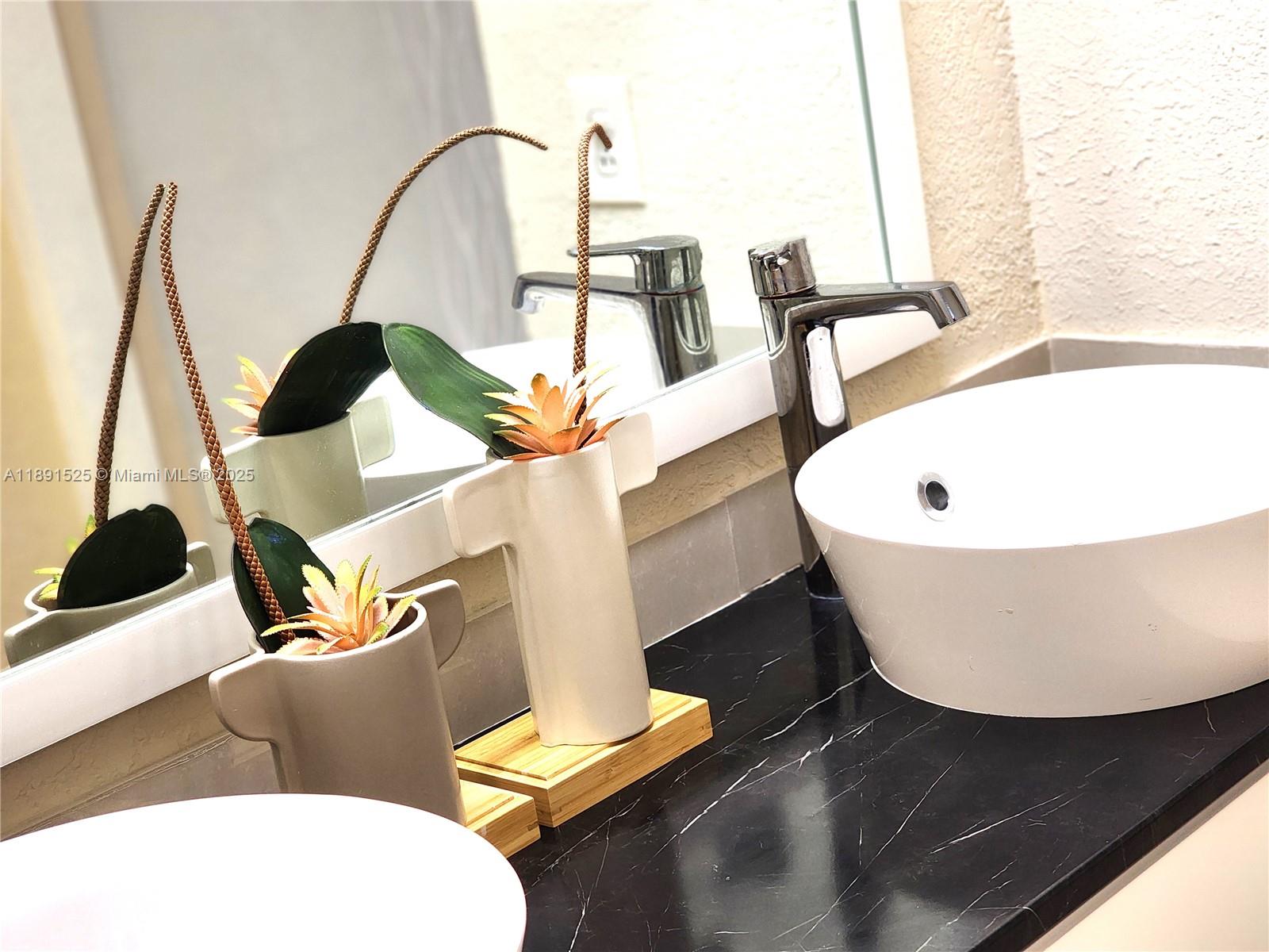 800 Southeast 20th Avenue, Unit 1109 Deerfield Beach, FL 33441 - Photo 18 of 19 a white tub sitting next to a white sink