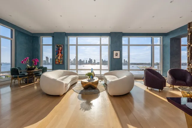 a living room with furniture and large windows