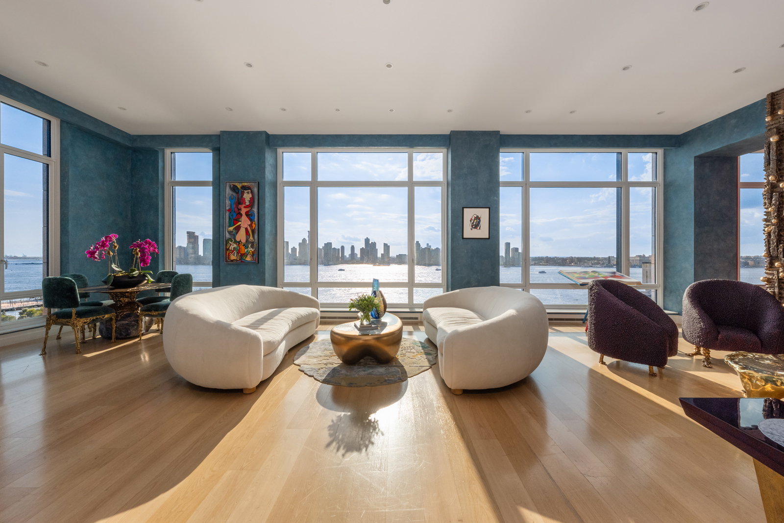 a living room with furniture and large windows