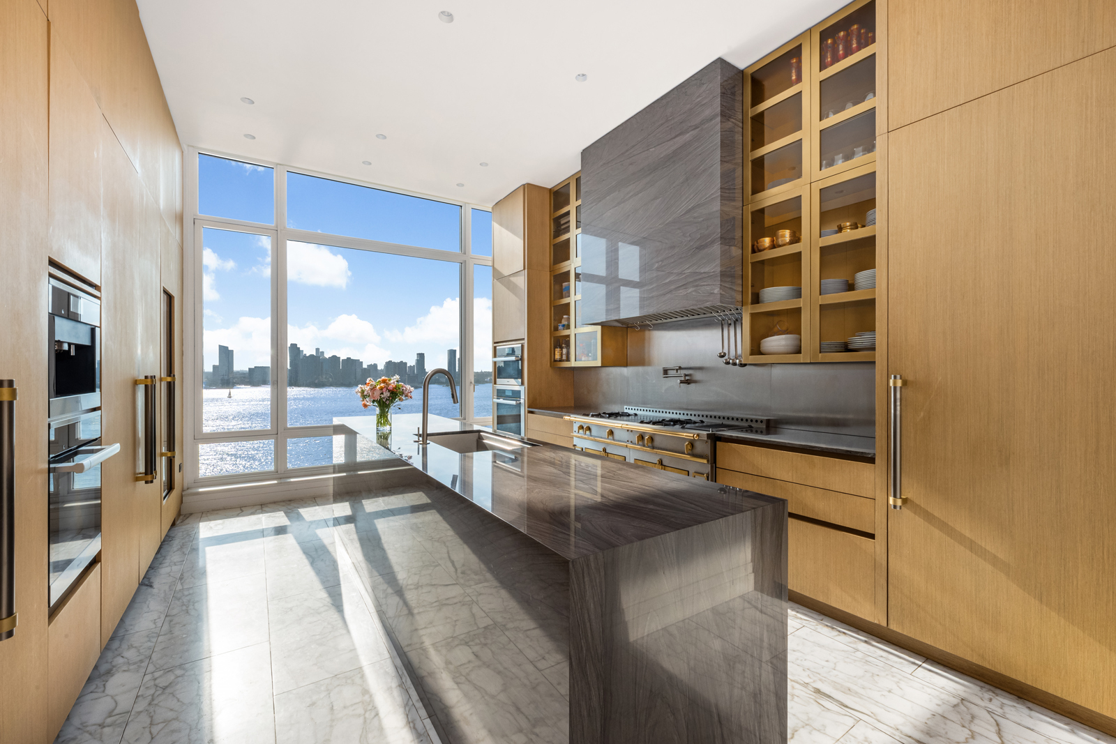 70 Vestry Street, Unit PHS Manhattan, NY 10013 - Photo 9 of 34 a kitchen with stainless steel appliances granite countertop a stove and a sink