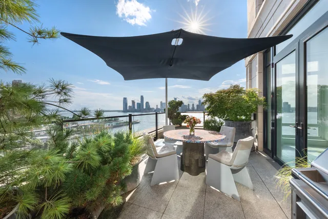 a view of a dining table and chairs in patio