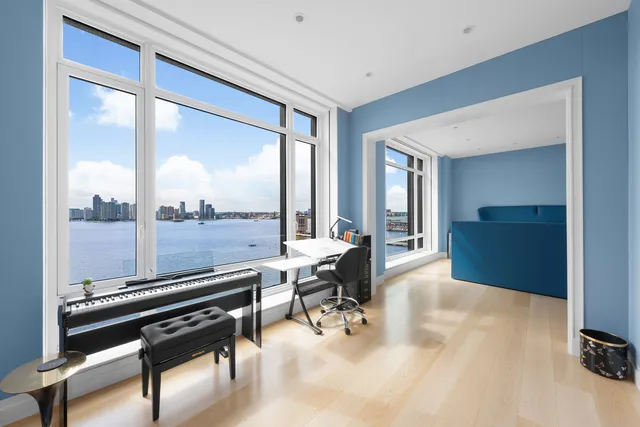 a view of a patio with table and chairs potted plants with floor to ceiling window