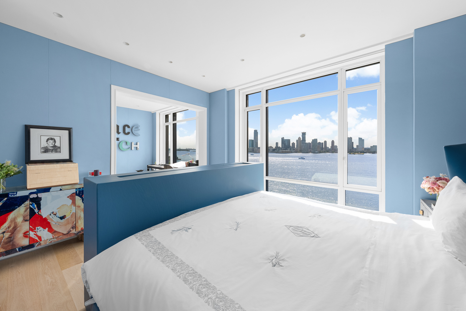 70 Vestry Street, Unit PHS Manhattan, NY 10013 - Photo 17 of 34 a bedroom with a bed and a large window with the outer view