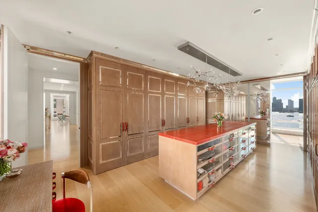 a living room with furniture water view and large windows