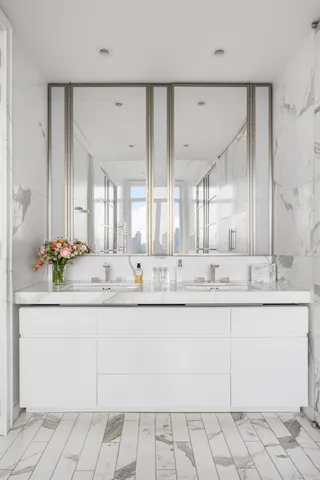 a bedroom with a bed and a large window with the outer view