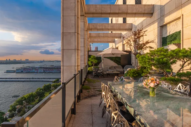 a view of roof deck with a barbeque and wooden stairs