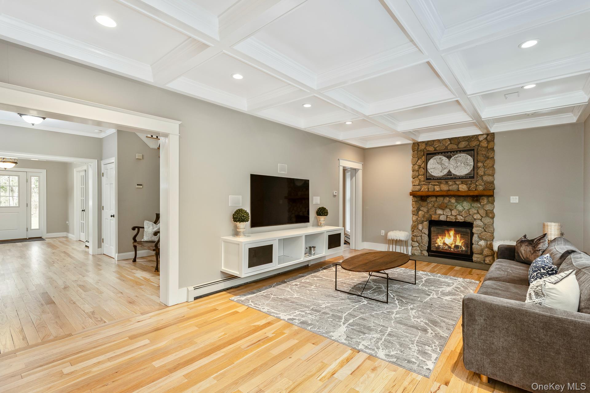 26 Box Tree Road East Quogue, NY 11942 - Photo 15 of 49 a living room with furniture a fireplace and a flat screen tv