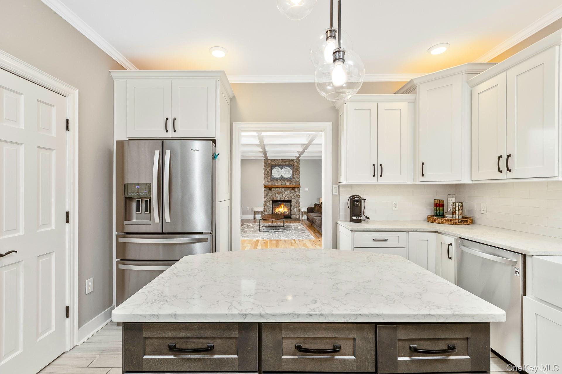 26 Box Tree Road East Quogue, NY 11942 - Photo 18 of 49 a kitchen with kitchen island a counter top space a sink stainless steel appliances and cabinets