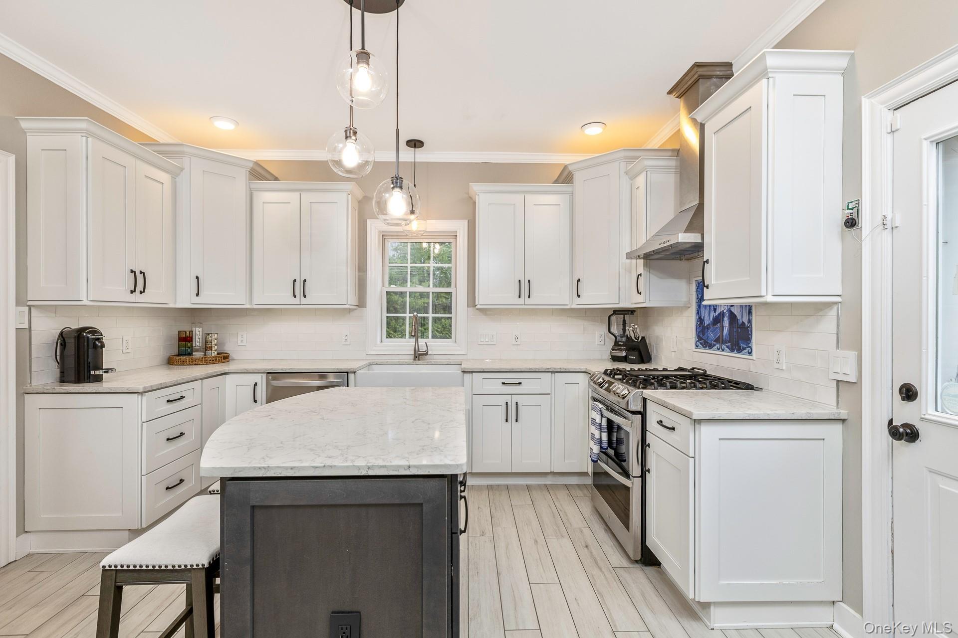 26 Box Tree Road East Quogue, NY 11942 - Photo 19 of 49 a kitchen with cabinets appliances and a wooden floor